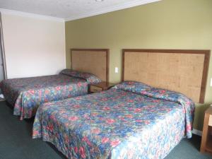 a hotel room with two beds in a room at National Inn Garden Grove in Anaheim