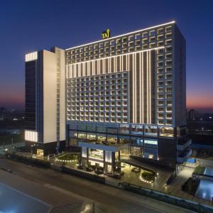 a large hotel building with a sign on top of it at Taj Skyline Ahmedabad in Ahmedabad