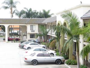 a group of cars parked in front of a building at National Inn Garden Grove in Anaheim