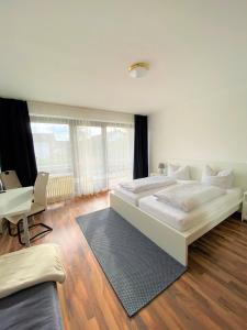 a bedroom with a large bed and a desk at Römerhof in Bad Bellingen