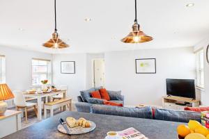 a living room with two couches and a table at The Harrogate Penthouse in Harrogate