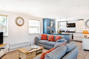 a living room with a couch and a table at The Harrogate Penthouse in Harrogate