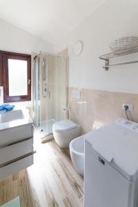 a bathroom with a toilet and a sink and a shower at VILLA ALOE in Costa Paradiso