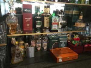 a shelf filled with lots of bottles of alcohol at Antik Hotel Sofia in Litomyšl