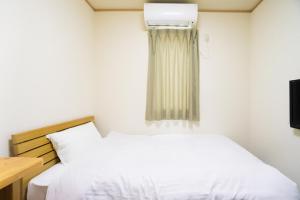 Tabist Hotel Daimu Minami-Souma客房内的一张或多张床位