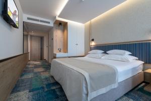 Postel nebo postele na pokoji v ubytování Hotel Sunce Neum