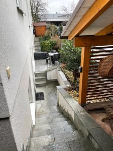 a small patio with a table and stairs next to a building at Ferienwohnung Casa Mia in Leimen