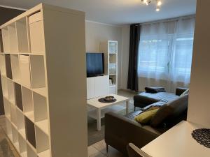 a living room with a couch and a tv at Ferienwohnung Casa Mia in Leimen