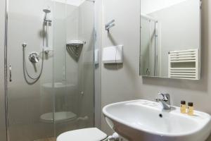 a bathroom with a shower and a sink and a toilet at Hotel Cannaregio 2357 in Venice