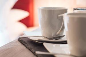 two cups of coffee sitting on a table at Hotel Cannaregio 2357 in Venice