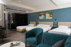 Postel nebo postele na pokoji v ubytování E-DA Skylark Hotel