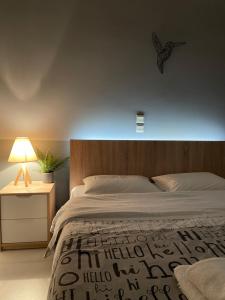 a bedroom with a bed and a lamp on a table at Aggelikis House in Spata