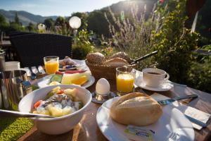 einen Tisch mit einer Schüssel Essen und einem Korb Brot in der Unterkunft Hotel Restaurant Sonnenlay in Kröv