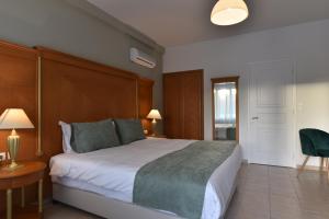 a bedroom with a large bed and a table and chairs at Okeanis II in Kato Daratso