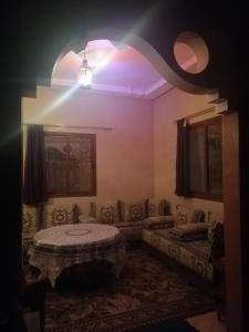 a living room with a couch and a table at Auberge Tilila in Tafraoute +54 photos