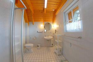 a bathroom with a toilet and a sink at Strandvogt 2 ES7 in Dorum Neufeld