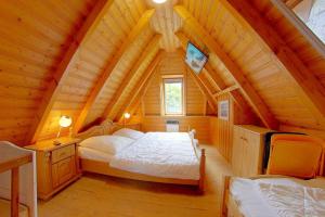 a bedroom with a bed in a wooden house at Strandvogt 2 ES7 in Dorum Neufeld