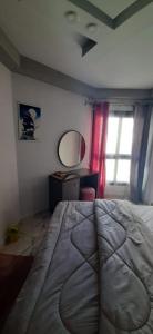 a bedroom with a bed and a mirror and a window at Porto Said in Port Said