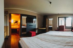 een hotelkamer met een groot bed en een slaapkamer bij Burghotel Pass in Südlohn