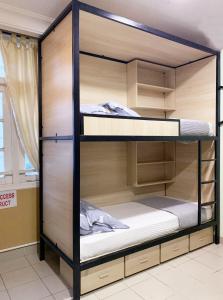 a set of bunk beds in a room at Snooze Inn @Dickson Road in Singapore