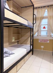 a bunk bed room with two bunk beds at Snooze Inn @Dickson Road in Singapore