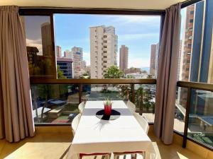 a room with a white table and a large window at Torpa - Aloturin Benidorm in Benidorm