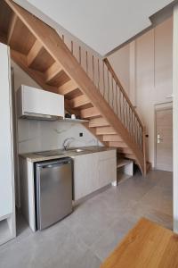 a kitchen with a sink and a staircase at Albatros Luxury Suites in Nea Vrasna +34 photos