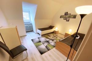 a small living room with a couch and a lamp at Cozy apartments Eslohe in Eslohe