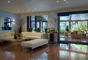 a living room with a couch and a table at Best Western Hotel Mediterraneo in Castelldefels