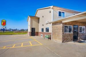 a building with a parking lot in front of it at Super 8 by Wyndham Fort Madison in Fort Madison