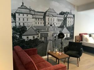 a living room with a wall mural of a castle at Altstadthotel Arte in Fulda