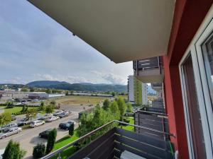 a balcony with a view of a parking lot at Apartment Richy Brasov in Braşov