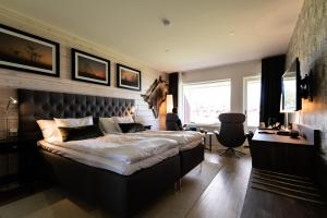 a bedroom with a large bed and a desk at Kukkolaforsen Turist & Konferens in Haparanda