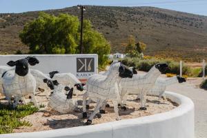 a statue of sheep standing in a fence at Karoo 1 Hotel Village in De Doorns