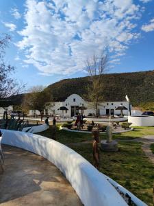 a park with a white building in the background at Karoo 1 Hotel Village in De Doorns