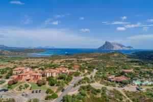an aerial view of a town with the ocean at Residence Hotel Lu Nibareddu in San Teodoro