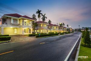 a row of houses on a street at night at Pattana Sports Resort in Si Racha