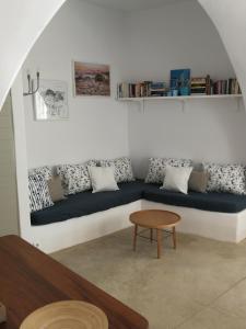 a living room with a couch and a table at Chora Elegant Traditional House in Amorgos