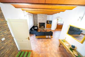 a living room with a couch and a tv at Casa Rural Casa Las Flores in Tíjola