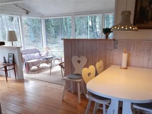 een keuken met een tafel en stoelen en een woonkamer bij Granly in Ans
