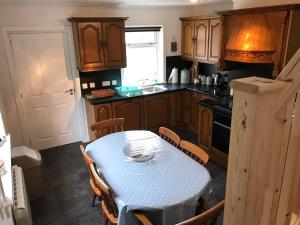 a kitchen with a table with a blue table cloth on it at Cuckoos Rock in Graver