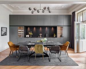 a dining room with a black table and chairs at MN6 Luxury Suites by Prague Residences in Prague