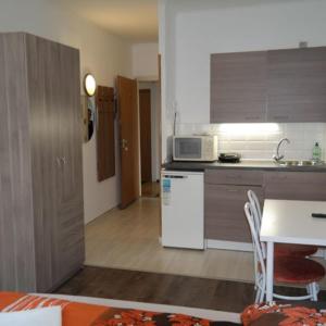 a kitchen with a sink and a microwave at West City Apartments in Budapest