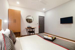 een hotelkamer met een bed en een flatscreen-tv bij Hotel The Onyx in Nagpur
