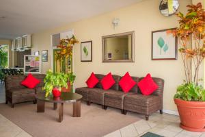 a living room with red pillows on a couch at Bay Gardens Inn in Gros Islet