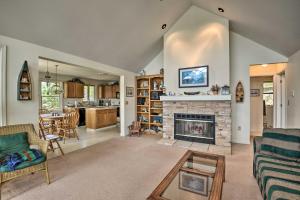 a living room with a fireplace and a kitchen at Waterfront Hammond Home with Grill and Boat Dock! in Hammond