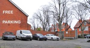 cars parked in front of a brick building at Morehampton Townhouse in Dublin