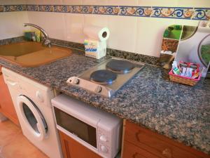 a kitchen with a stove top oven next to a sink at Anamar Kione Rentals in Alcossebre