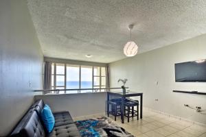 a living room with a couch and a table at Rincon Penthouse Steps to Private Beach Oasis! in Rincon
