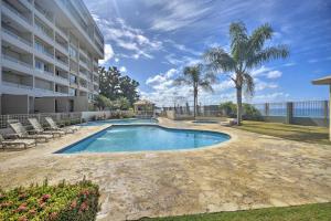 a swimming pool in front of a building at Rincon Penthouse Steps to Private Beach Oasis! in Rincon